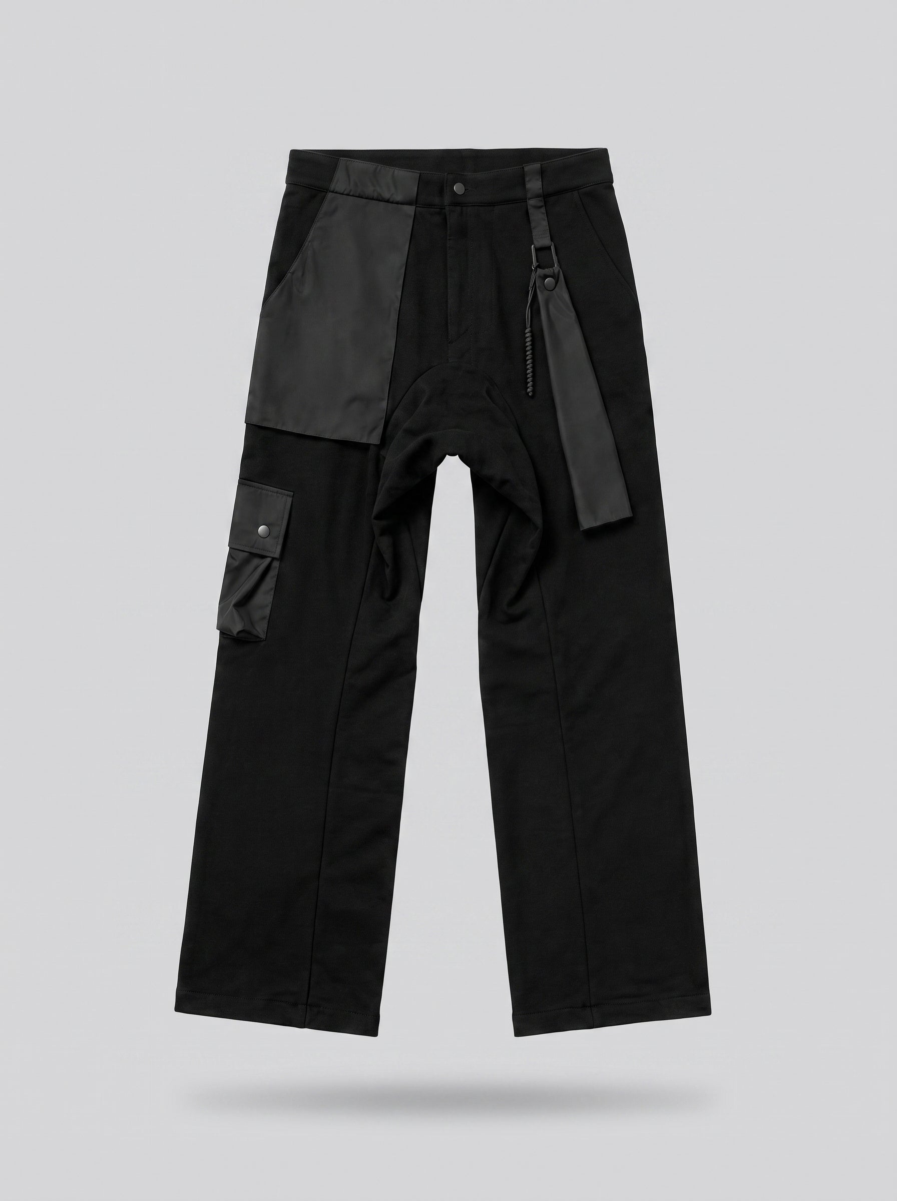 Black pants with gray patches on a light gray background