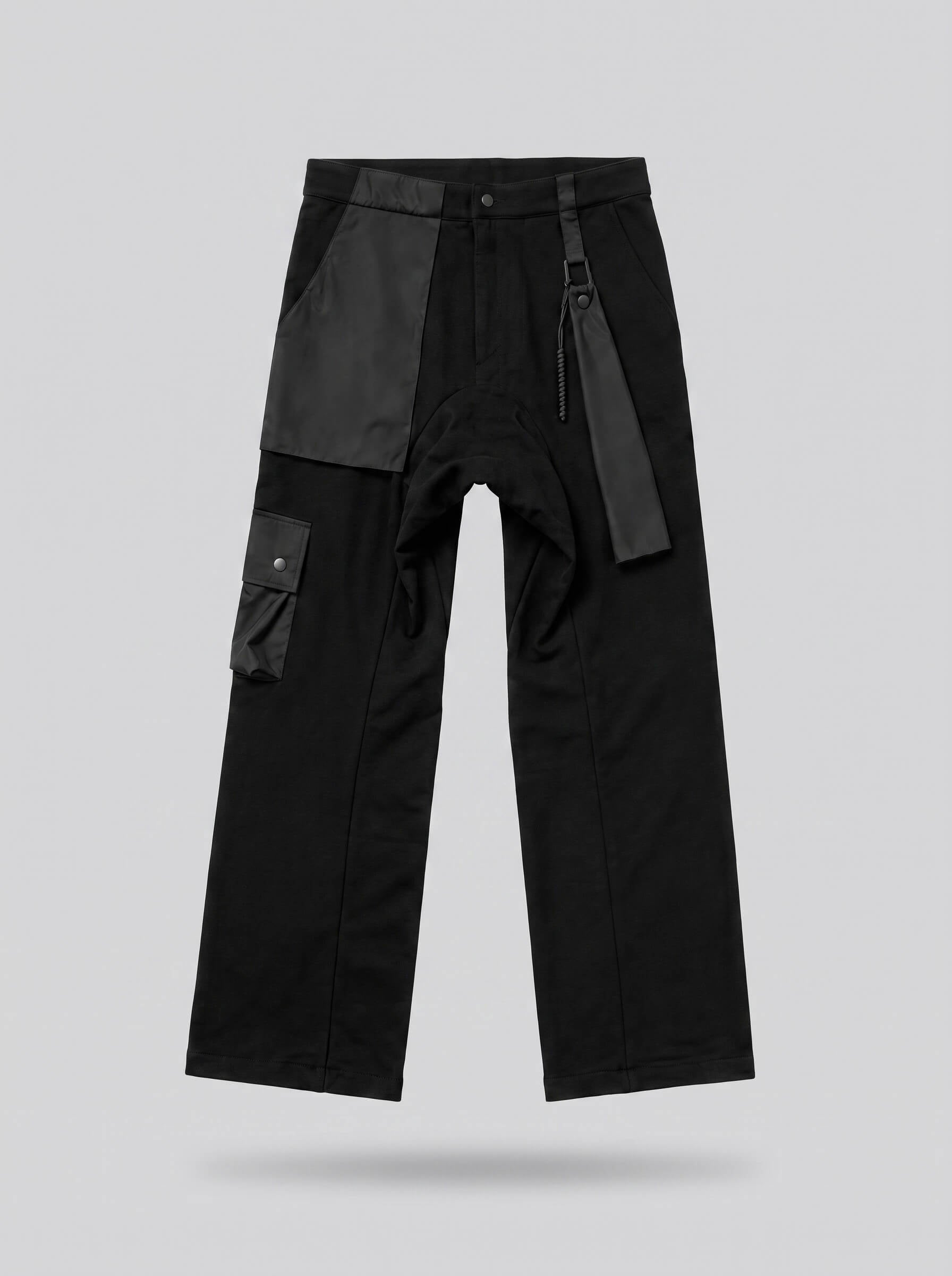 Black pants with gray patches on a light gray background