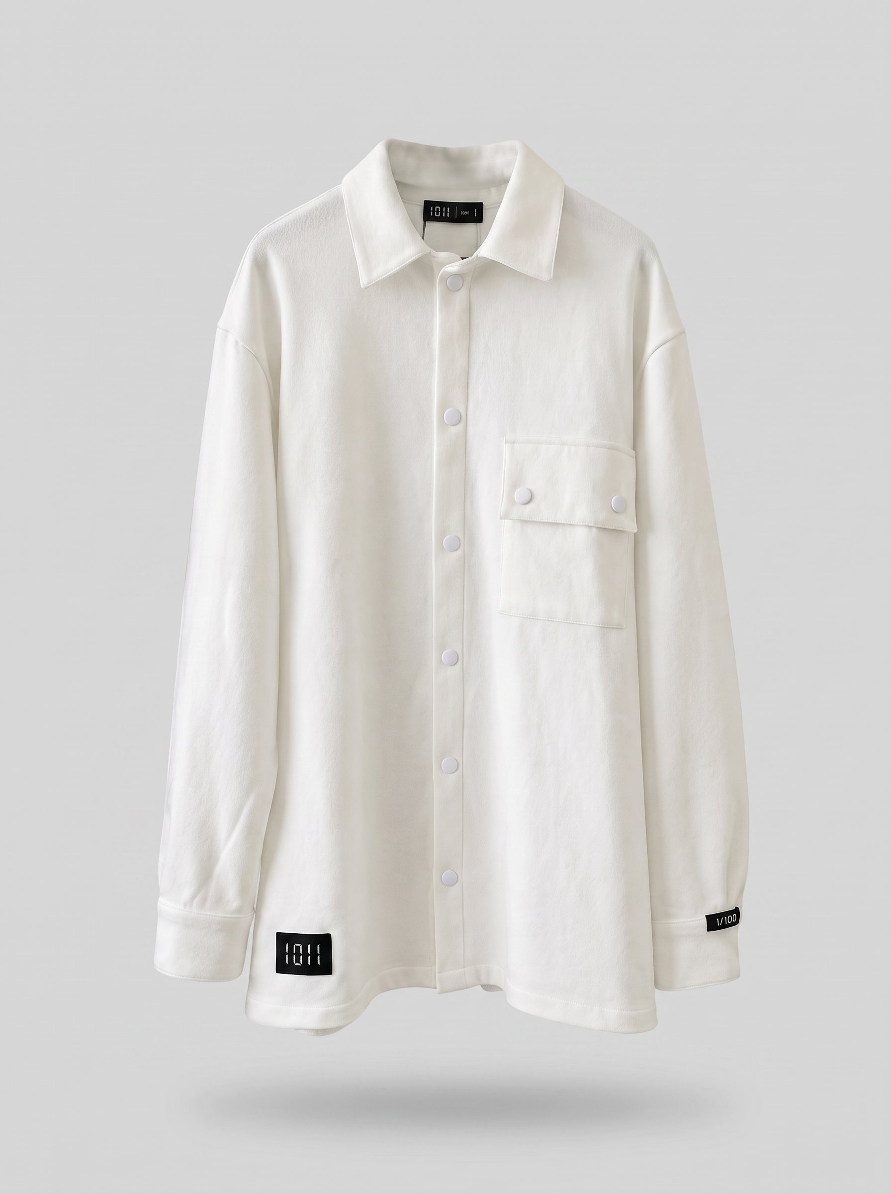 White shirt with black labels on a light gray background
