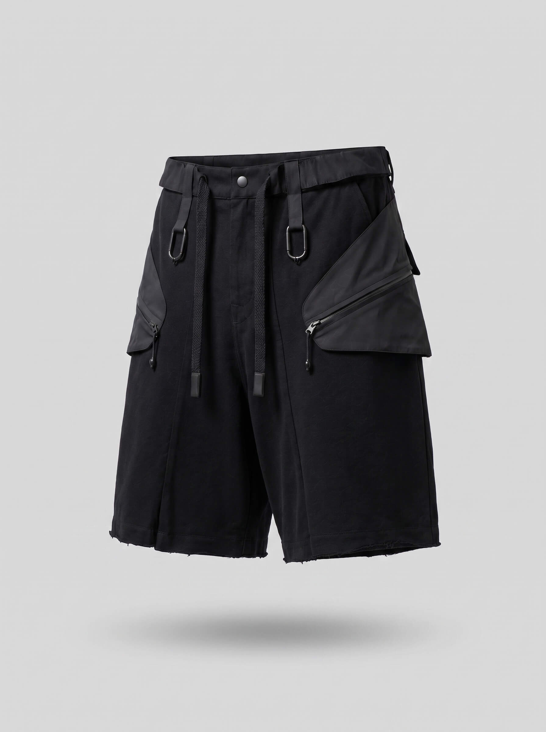 Black tactical shorts with multiple pockets and zippers on a gray background