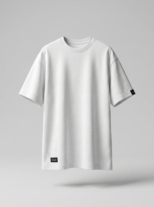 White t-shirt with a small black label on a gray background